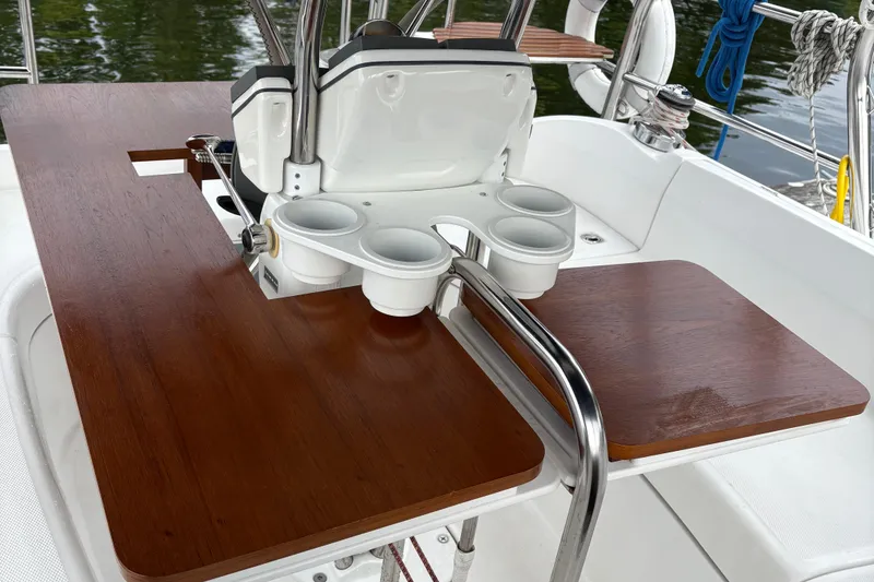 Slide: The Image of Cockpit table and helm of 2006 Hunter 33 sailboat with cup holders. - 7
