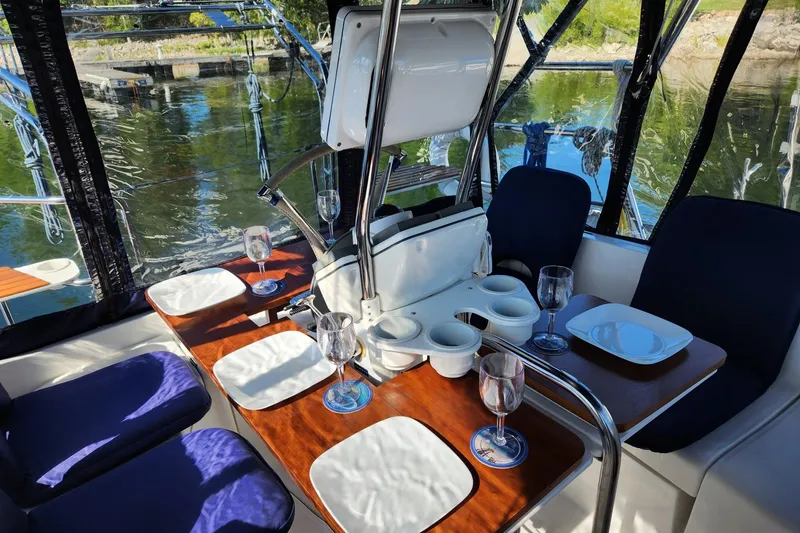 Slide: The Image of Interior of 2006 Hunter 33 sailboat with dining setup and scenic water view. - 8