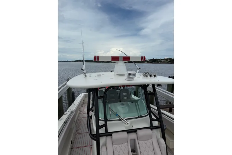 Slide: The Image of 2013 Hydra-Sports 42 boat docked by the water, featuring a sleek design and radar equipment. - 11