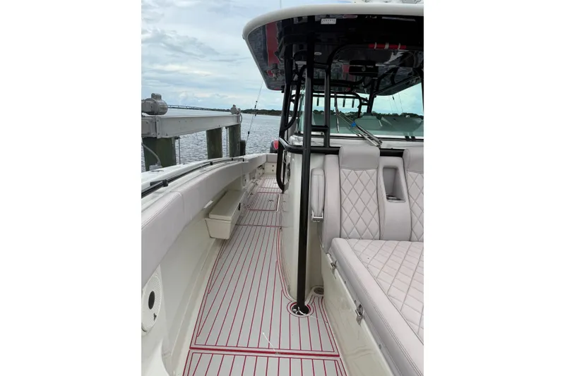 Slide: The Image of 2013 Hydra-Sports 42 boat interior with quilted seating and striped flooring. - 14