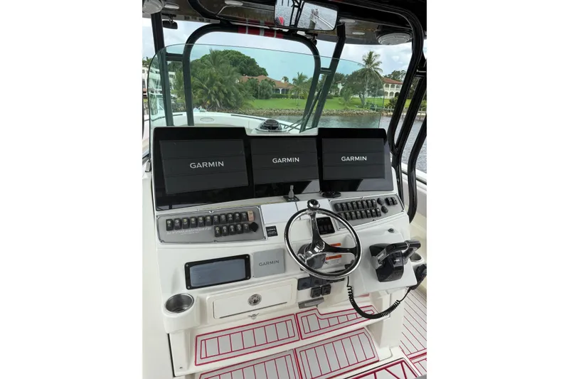 Slide: The Image of 2013 Hydra-Sports 42 boat dashboard with Garmin navigation displays and steering wheel. - 15