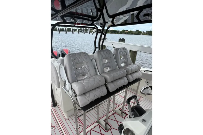 Slide: The Image of Luxurious seating on 2013 Hydra-Sports 42 boat, featuring quilted leather design and scenic water view. - 16