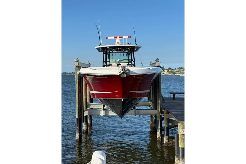 Slide: The Image of 2013 Hydra-Sports 42 boat docked on lift over water. - 2