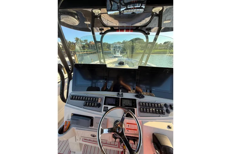 Slide: The Image of 2013 Hydra-Sports 42 boat cockpit with advanced navigation controls and steering wheel. - 6