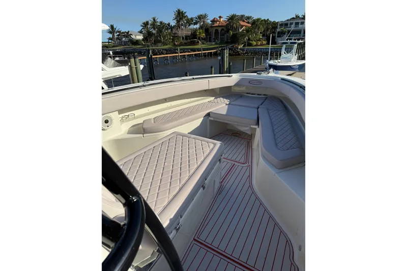 Slide: The Image of 2013 Hydra-Sports 42 boat interior with cushioned seating and waterfront view. - 8