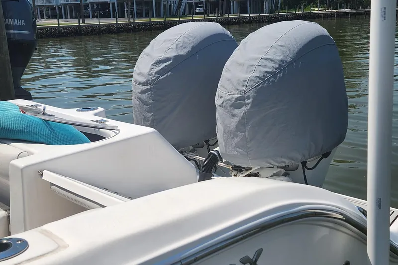 Slide: The Image of 2019 Sea Fox 266 Commander boat with covered outboard motors on a calm waterway. - 12