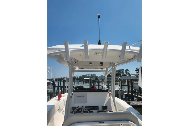 Slide: The Image of 2019 Sea Fox 266 Commander boat with T-top and rod holders, docked at marina. - 14