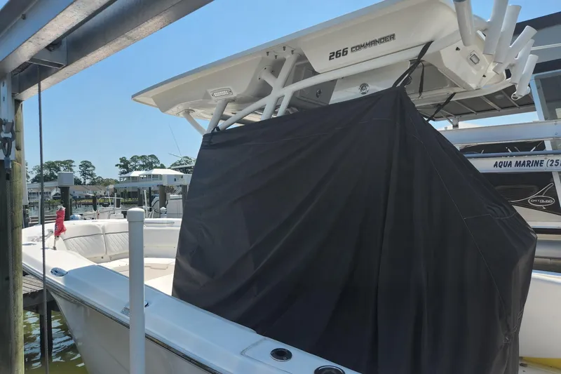 Slide: The Image of 2019 Sea Fox 266 Commander boat docked with cover, showcasing sleek design and spacious seating. - 3