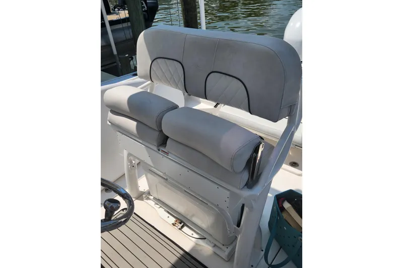 Slide: The Image of 2019 Sea Fox 266 Commander boat seat with gray upholstery and storage underneath. - 9