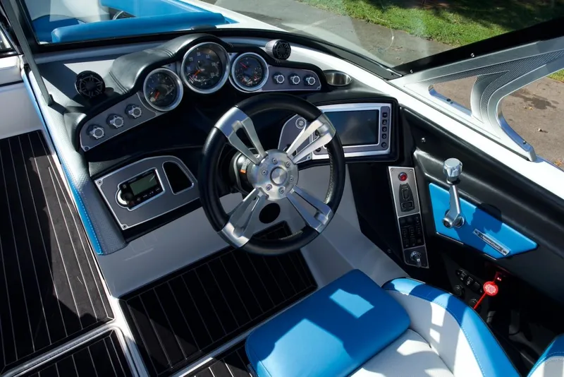 Slide: The Image of 2017 MasterCraft X26 boat cockpit with modern steering wheel and dashboard controls. - 14