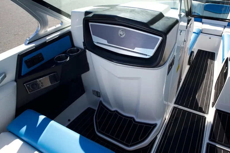 Slide: The Image of 2017 MasterCraft X26 boat interior with blue seating, cup holders, and sleek dashboard design. - 15