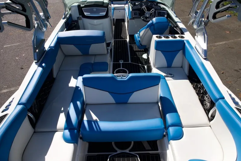 Slide: The Image of 2017 MasterCraft X26 boat interior with blue and white seating, showcasing luxury and comfort. - 17