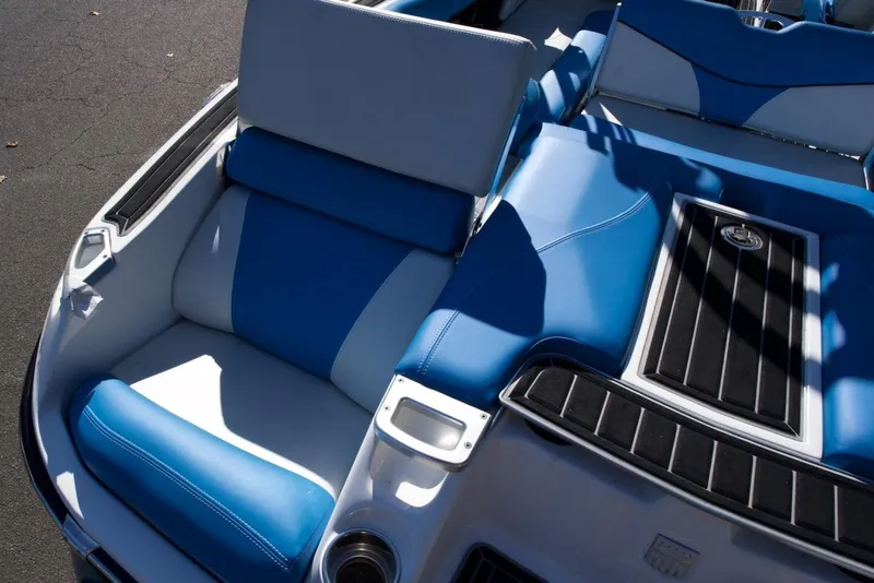 Slide: The Image of 2017 MasterCraft X26 boat interior with blue and white seating, featuring sleek design elements. - 19