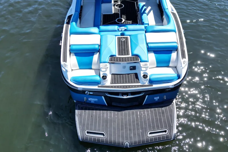 Slide: The Image of 2017 MasterCraft X26 boat with blue and white seating, floating on water. - 8