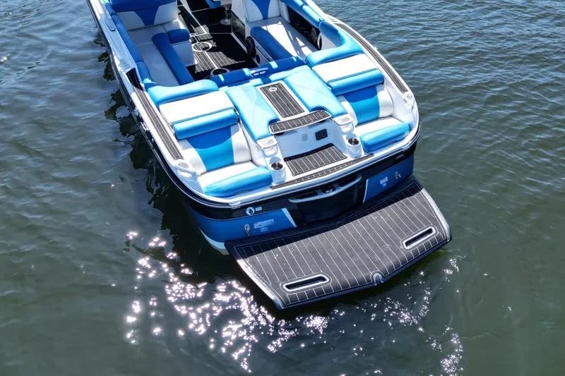 Slide: The Image of 2017 MasterCraft X26 boat with blue seating on calm water. - 9