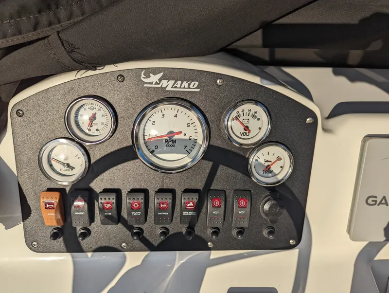 Slide: The Image of Dashboard of a 2017 Mako 204 Center Console boat with gauges and switches. - 12