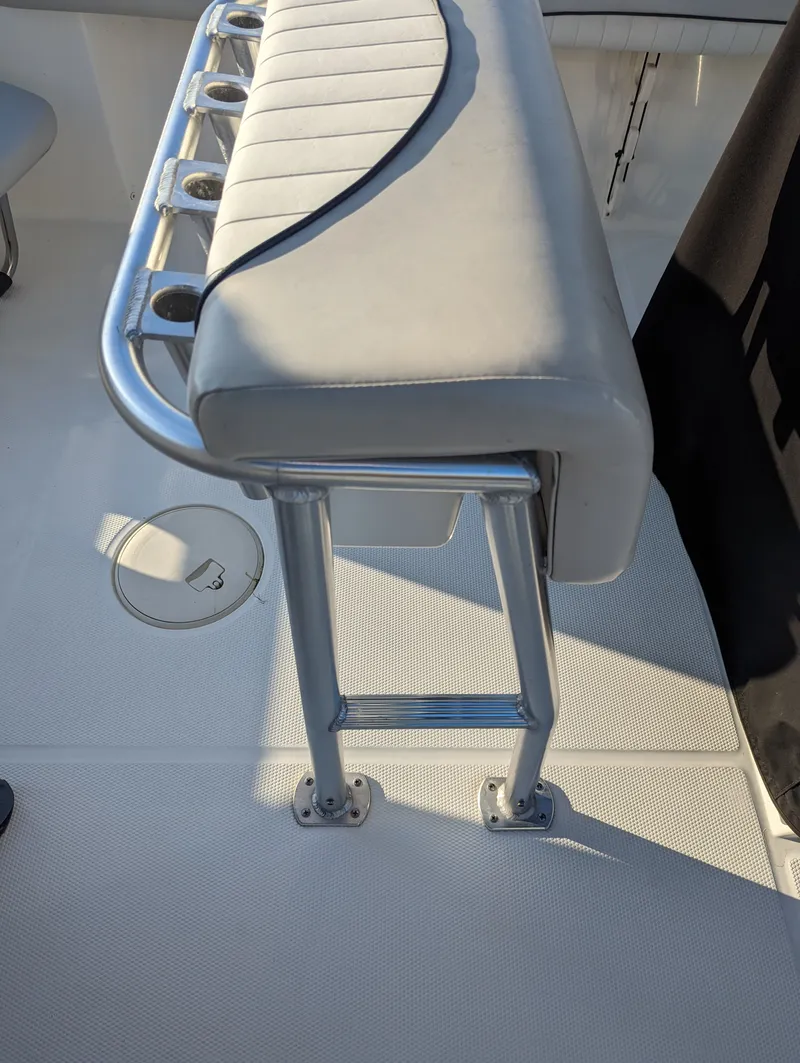 Slide: The Image of 2017 Mako 204 Center Console boat seat with rod holders and stainless steel frame. - 17