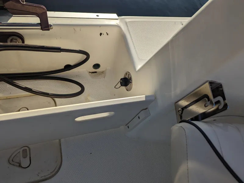 Slide: The Image of Interior view of a 2017 Mako 204 Center Console boat, showing seating and control panel. - 19