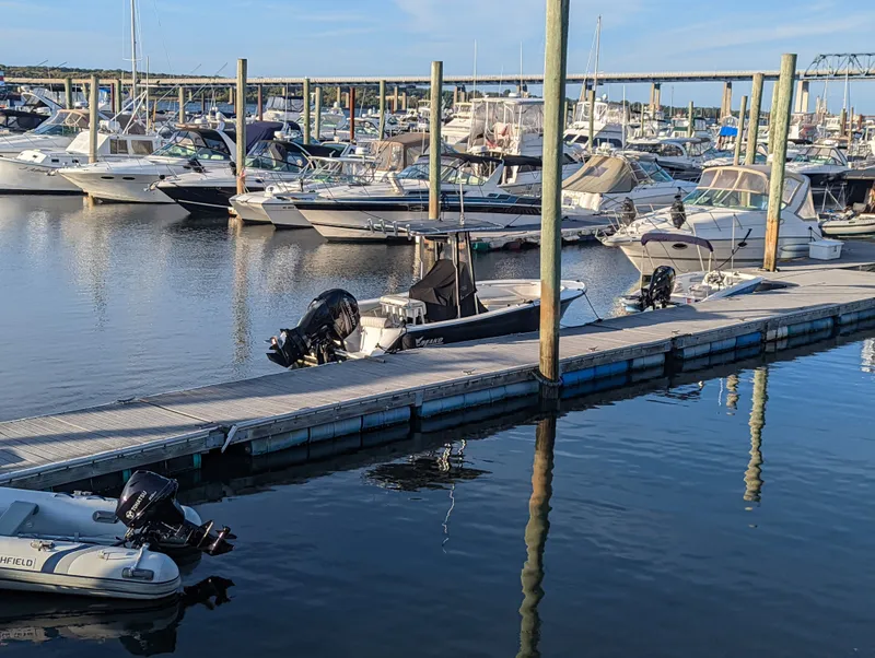 Slide: The Image of Boats docked at a marina, featuring a 2017 Mako 204 Center Console. - 21