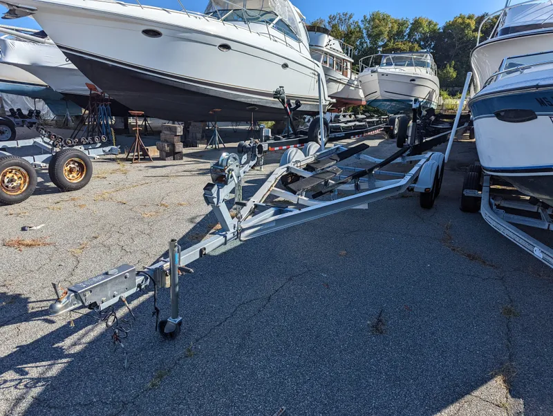 Slide: The Image of Boat trailer in a marina with various boats, including a 2017 Mako 204 Center Console. - 4