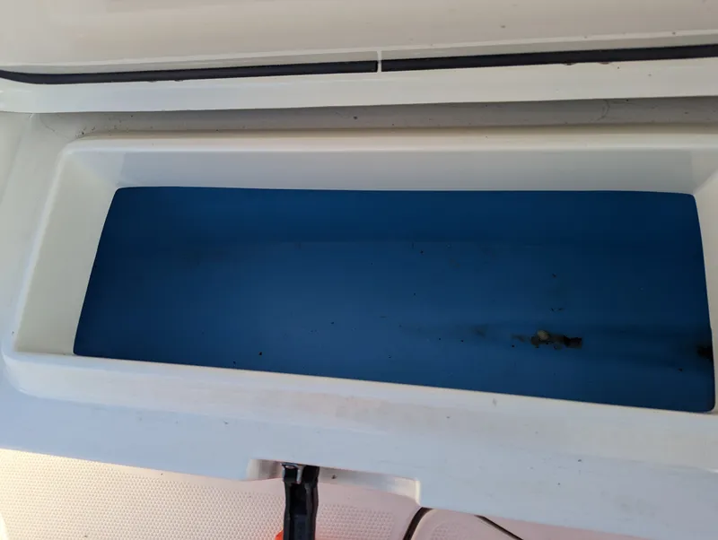 Slide: The Image of Open storage compartment on a 2017 Mako 204 Center Console boat. - 9