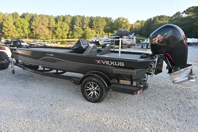 Slide: The Image of 2022 Vexus AVX1980 boat with Mercury engine, parked on gravel near a lake. - 4