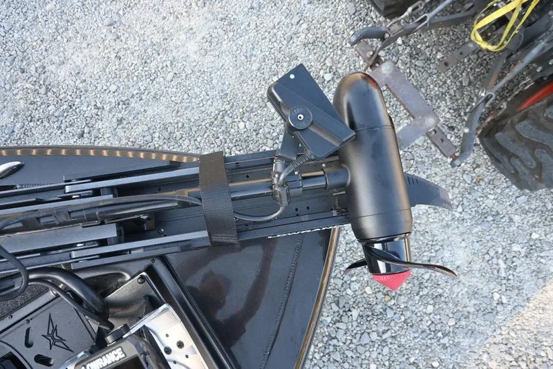 Slide: The Image of 2022 Vexus AVX1980 boat with mounted trolling motor on gravel surface. - 7