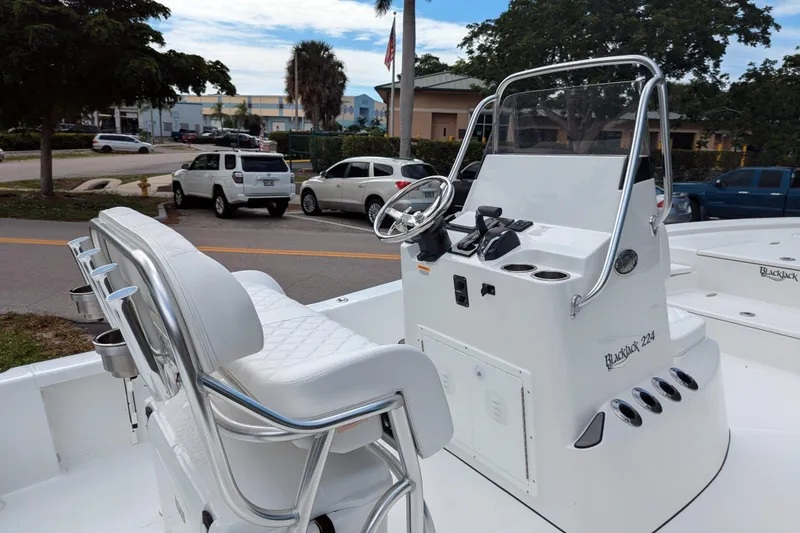Slide: The Image of Steering console of 2026 BlackJack 224 boat with controls and cup holders. - 10