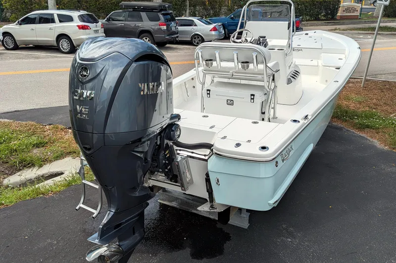 Slide: The Image of 2026 BlackJack 224 boat displayed outdoors at a yacht sales location. - 2