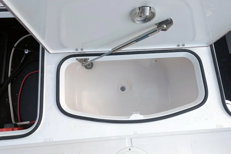 Slide: The Image of White K2 cooler on BlackJack 224 boat, 2026 model, secured under metal frame. - 25