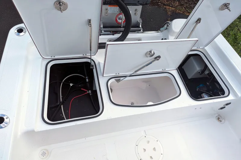 Slide: The Image of Interior view of BlackJack 224 boat's mechanical compartment, featuring pumps and hoses, 2026 model. - 26