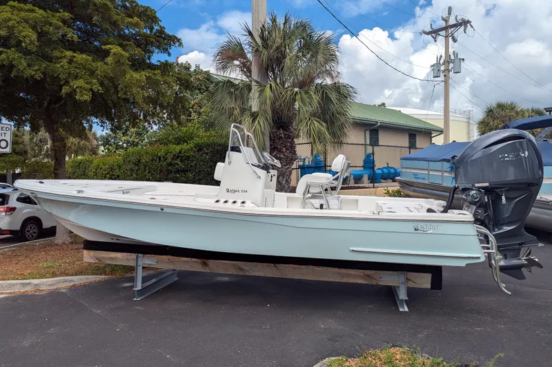 Slide: The Image of 2026 BlackJack 224 boat with Yamaha 300 V6 engine, parked on pavement. - 4