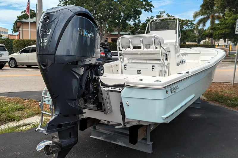 Slide: The Image of 2026 BlackJack 224 boat on display, featuring sleek design and powerful outboard motor. - 6