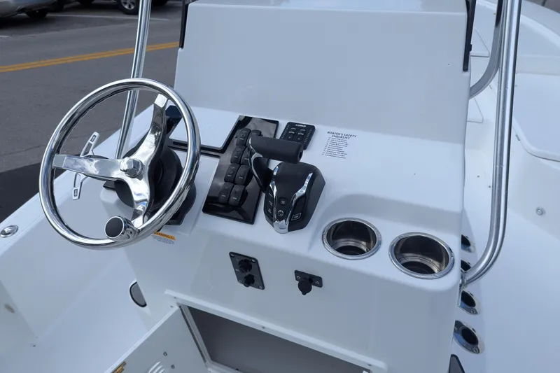 Slide: The Image of 2026 BlackJack 224 boat with Yamaha outboard motor, parked outdoors on a sunny day. - 8