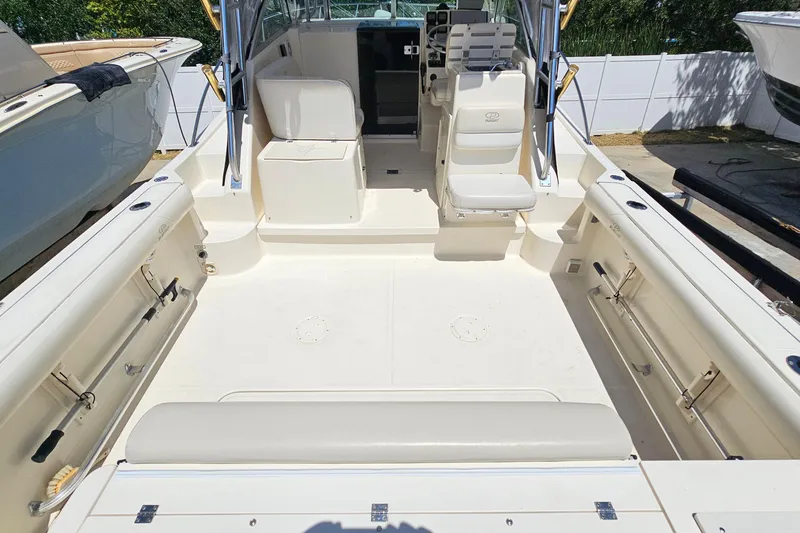 Slide: The Image of 2004 Pursuit 3070 Express boat interior with seating and storage compartments. - 15