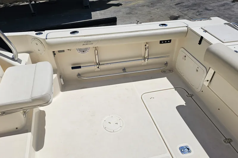 Slide: The Image of 2004 Pursuit 3070 Express boat interior with seating and storage compartments. - 16