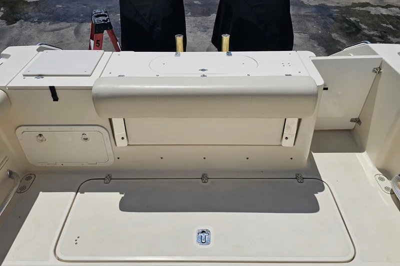 Slide: The Image of 2004 Pursuit 3070 Express boat deck with storage compartments and seating. - 18