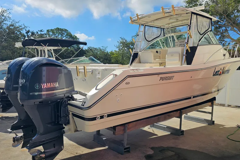 Slide: The Image of 2004 Pursuit 3070 Express boat with twin Yamaha engines on display. - 4