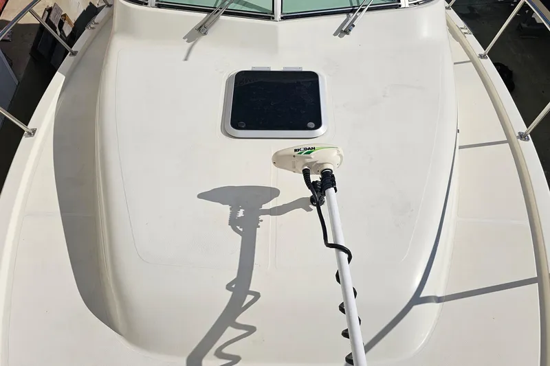 Slide: The Image of 2004 Pursuit 3070 Express boat deck with mounted equipment and hatch. - 8