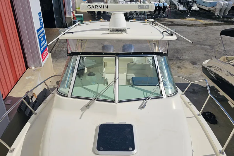 Slide: The Image of 2004 Pursuit 3070 Express boat with Garmin radar, docked at a marina. - 9