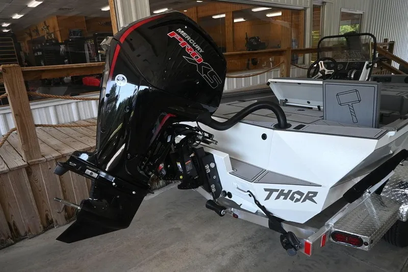 Slide: The Image of 2026 Thor Lake Hammer 1900CC boat with Mercury Pro XS engine in showroom. - 2