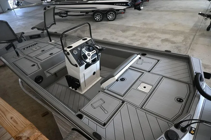 Slide: The Image of 2026 Thor Lake Hammer 1900CC boat interior with steering console and storage compartments. - 3