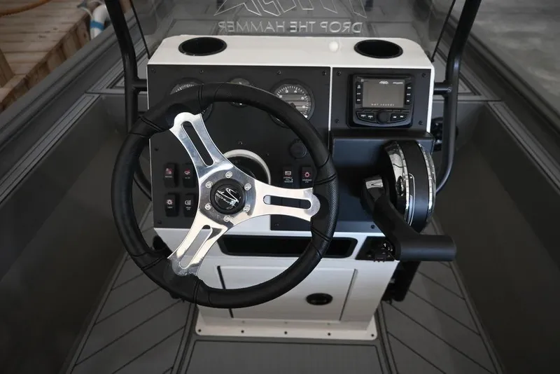 Slide: The Image of 2026 Thor Lake Hammer 1900CC boat dashboard with steering wheel and controls. - 5