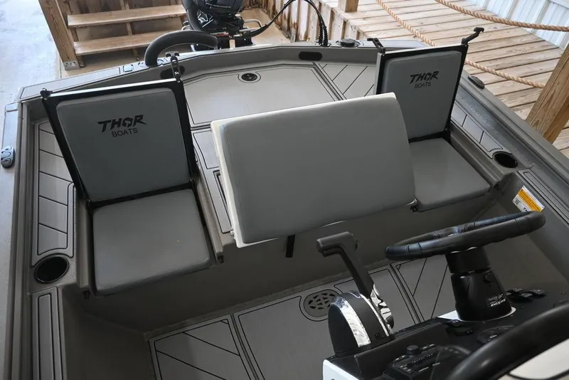 Slide: The Image of Interior of 2026 Thor Lake Hammer 1900CC boat with steering wheel and seating. - 8