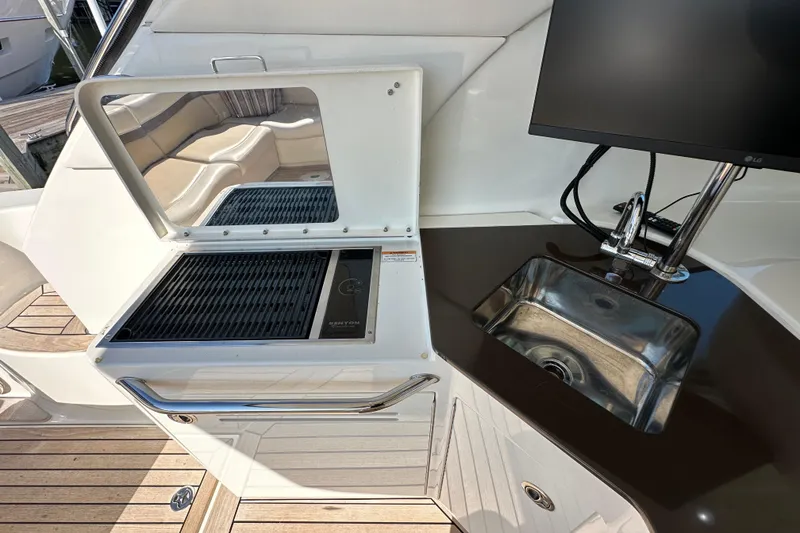 Slide: The Image of 2012 Sea Ray 470 Sundancer yacht kitchen with grill, sink, and countertop. - 10