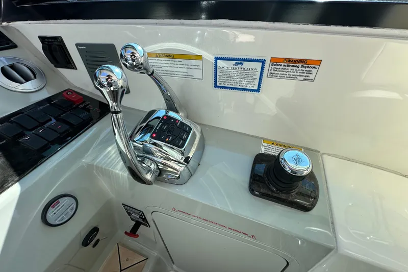 Slide: The Image of Control panel of 2012 Sea Ray 470 Sundancer yacht with throttle levers and joystick. - 17