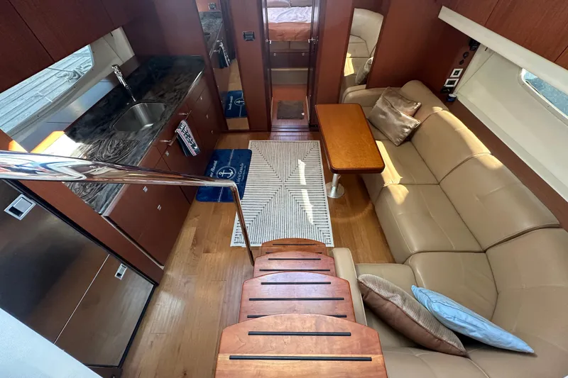 Slide: The Image of Luxurious interior of 2012 Sea Ray 470 Sundancer yacht with modern kitchen and cozy seating area. - 18