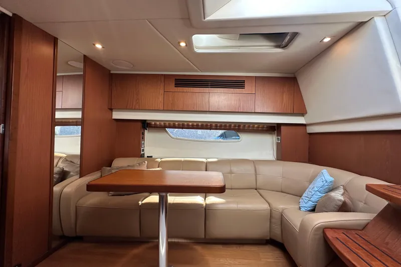 Slide: The Image of Luxurious interior of 2012 Sea Ray 470 Sundancer yacht with leather seating and wooden accents. - 19