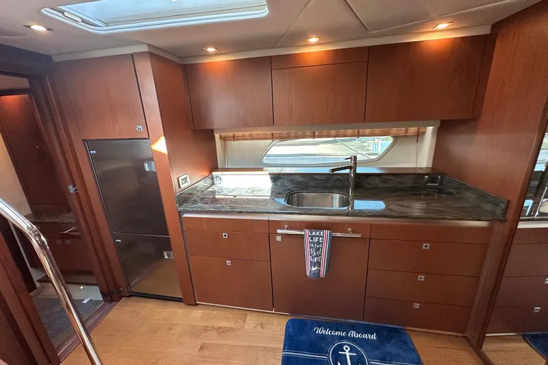 Slide: The Image of Luxurious kitchen interior of 2012 Sea Ray 470 Sundancer yacht with wood cabinetry. - 20