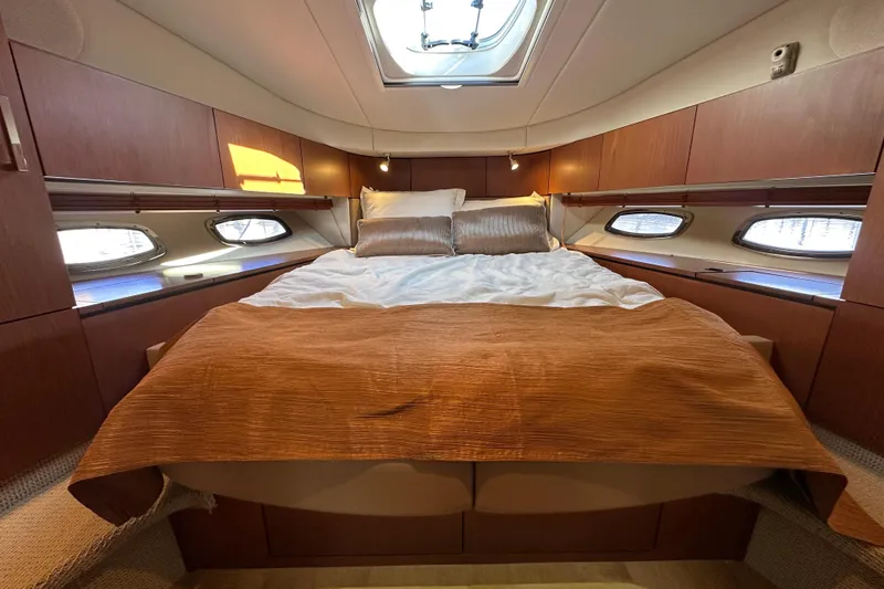 Slide: The Image of Luxurious cabin interior of 2012 Sea Ray 470 Sundancer yacht with cozy bedding. - 21